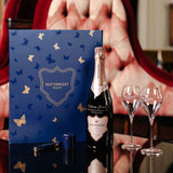 Lifestyle image of Hattingley Valley Luxury Gift Set with a bottle, two glasses and a stopper