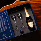 Lifestyle image of Hattingley Valley Luxury Gift Set with a bottle, two glasses and a stopper