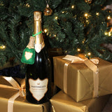 Bottle of Hatingley champagne with gold gift boxes under a Christmas tree.