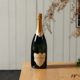 Bottle of Hattingley sparkling wine Classic Reserve NV Magnum on a wooden surface with a neutral background