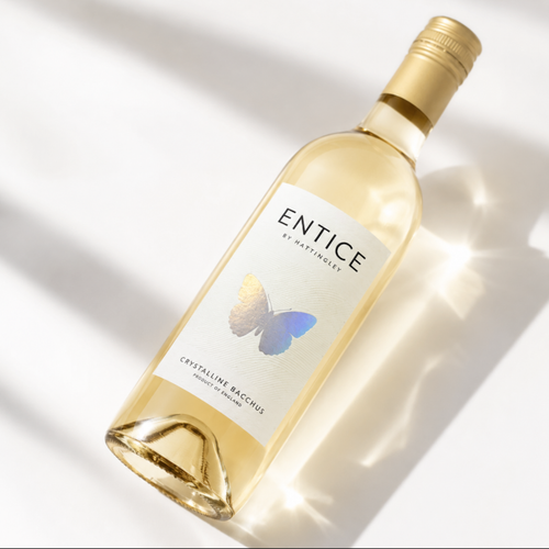 Bottle of Hattingley Valley Entice 2025 dessert wine sliver butterfly on the label on white background with light reflecting