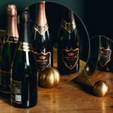 Hattingley Valley Premium English Sparkling Wines Kings Cuvée and Kings Rosé stood on a table reflected in two small mirror on the table, christmas bundle sparkling wines