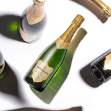 Hattingley Valley Classic Reserve bottles, at different angles, casting shadows on a white background