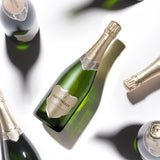 Hattingley Valley Blanc de Blancs bottles at various angles, casting shadows on a white background