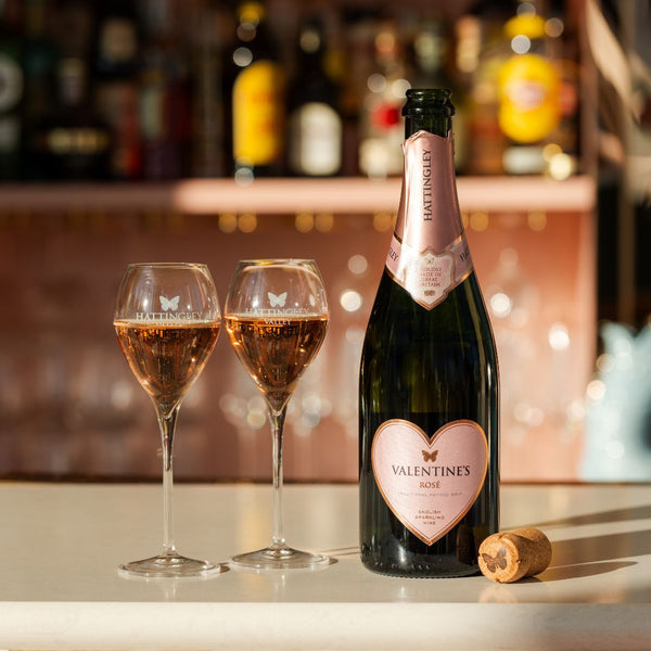 Hattingley Valley, Valentine's Day Rosé, Valentine's Rose bottle opened next to two filled glasses of English Sparkling Rosé, Gifts for Valentine's Day, Limited Edition