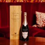 Lifestyle image of a bottle of Hattingley Valley Sparkling Rosé with an engraved oak wine box