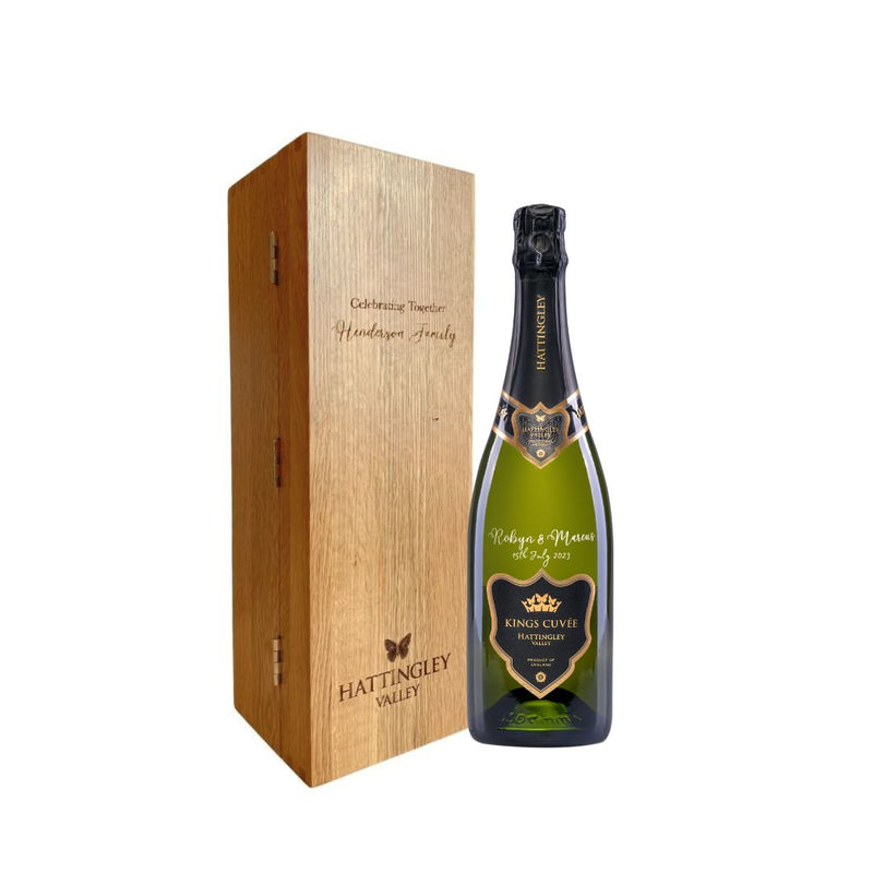 Web image of a Hattingley Valley Kings Cuvée bottle with engraving and an oak presentation wine box on a white background
