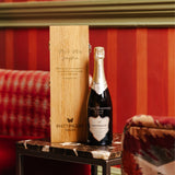 Lifestyle image of a bottle of Hattingley Valley Blanc de Blancs with an engraved oak wine box