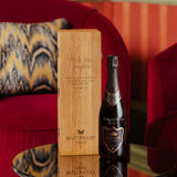 Hattingley Valley Kings Cuvée bottle with engraving and an oak presentation wine box with a lifestyle background 