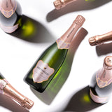 Hattingley Valley Sparkling Rosé case, premium English sparkling wine, Image of multiple Rosé bottles at various angles, casting shadows on the white bakground