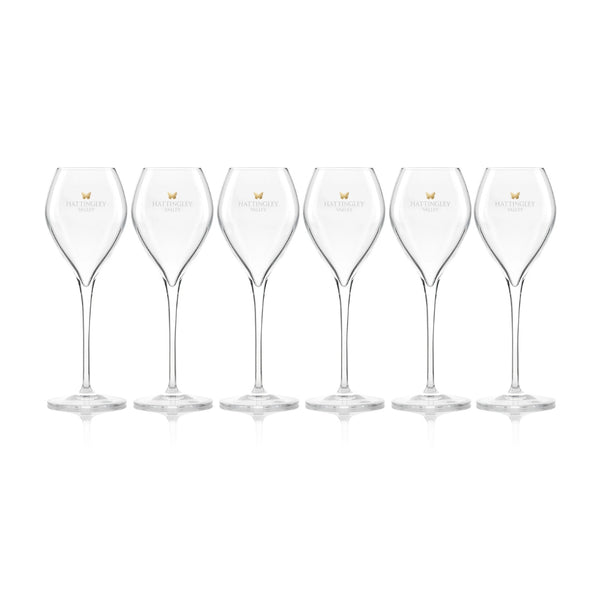 Hattingley Valley row of six Tulip Flutes (Glasses Empty), glasses are branded with the Hattingley Valley logo and butterfly. Fine glassware for drinking at home or giving as the perfect wine gift.
