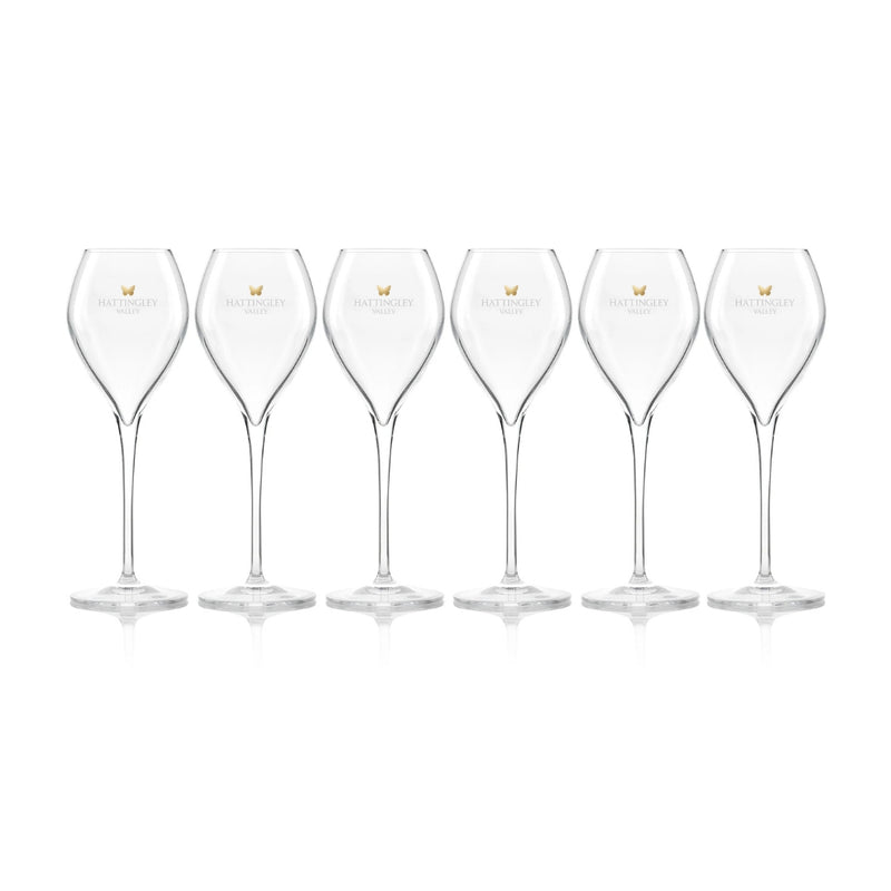 Hattingley Valley row of six Tulip Flutes (Glasses Empty), glasses are branded with the Hattingley Valley logo and butterfly. Fine glassware for drinking at home or giving as the perfect wine gift.
