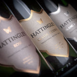 Hattingley Valley, lifestyle image, three english sparkling bottles close up, showing the Hattingley Valley Labels for our sparkling Rosé, Classic Reserve and our Blanc de Blancs.