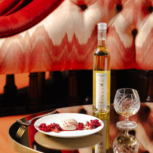 Hattingley Valley Lifestyle Image. Entice English dessert wine with summer pudding with a luxurious hotel background. English dessert wine. Best dessert wines.